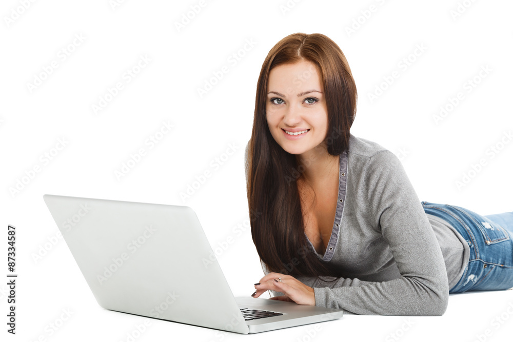 Beautiful young woman lying on floor with laptop Beautiful young woman lying on floor with laptop