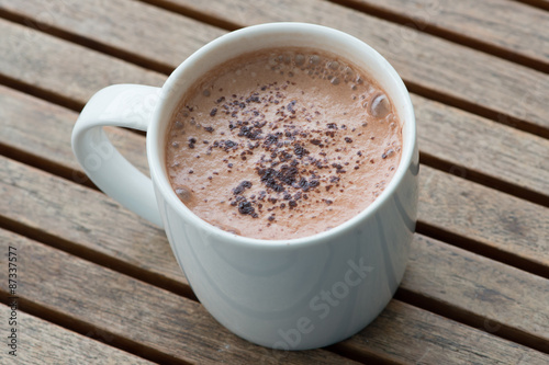 Hot chocolate in a white cup on table