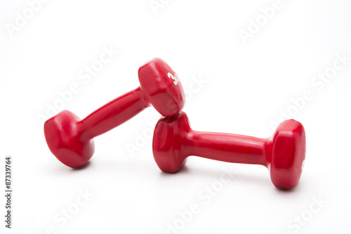 Red rubber dumbbell on white background.