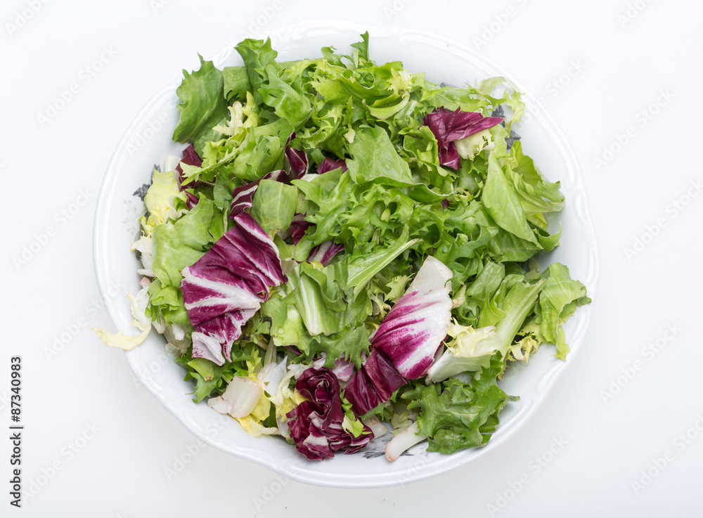 Green and red leaf of lettuce . Isolated on a white background Green and red leaf of lettuce . Isolated on a white background