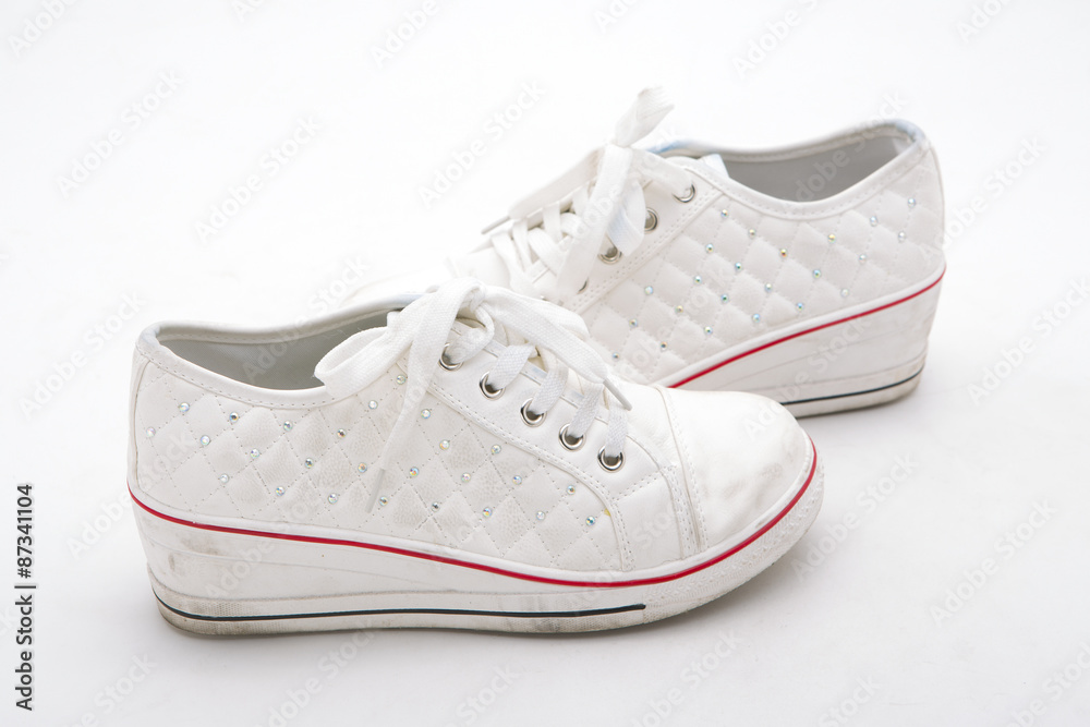 Pair of new white sneakers on white background Pair of new white sneakers on white background