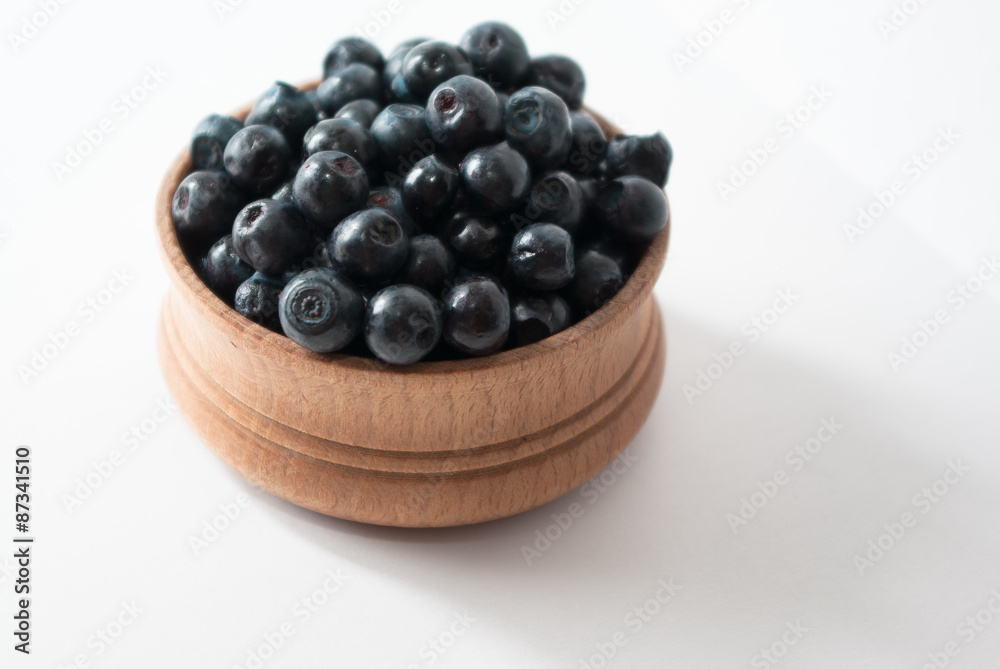 blueberries in a wooden bowl blueberries in a wooden bowl