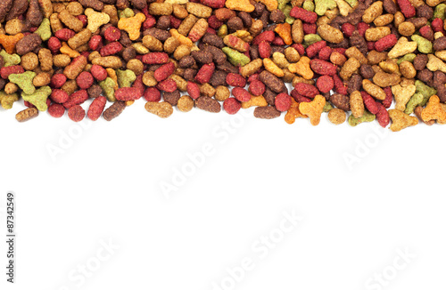 Dry multicolored pet food (dog or cat) on white background