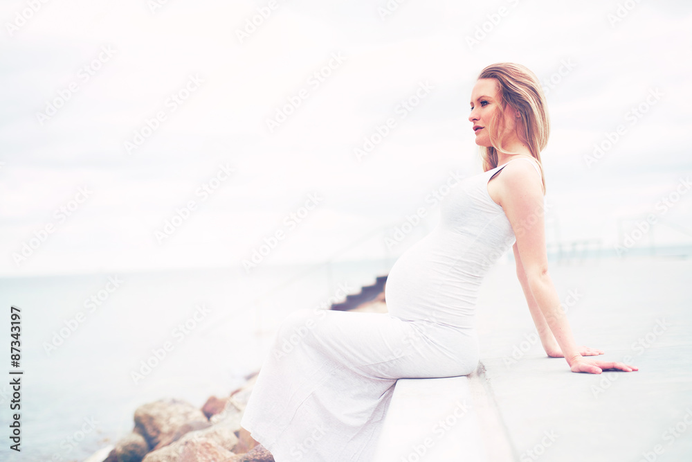 Healthy pregnant woman relaxing at the seaside