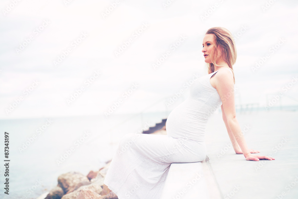 Healthy pregnant woman relaxing at the seaside