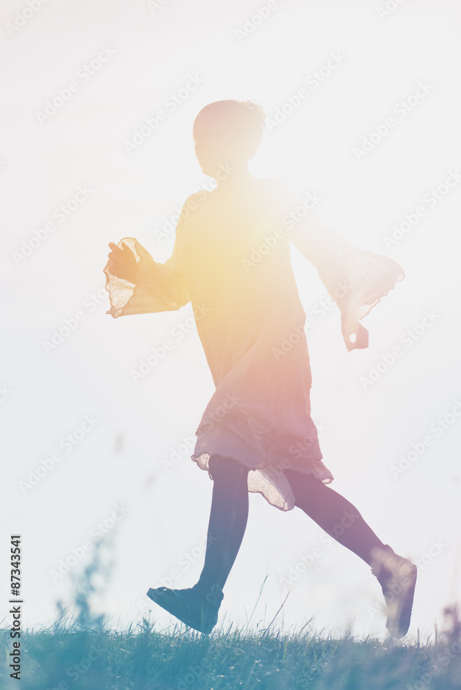 Woman Running to Freedom Through Countryside Field Woman Running to Freedom Through Countryside Field