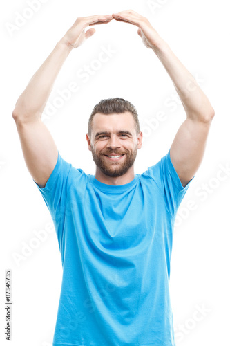 Smiling man holding arms above his head