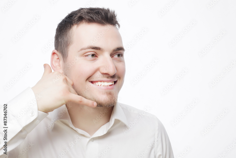 man gesturing mobile phone near his face