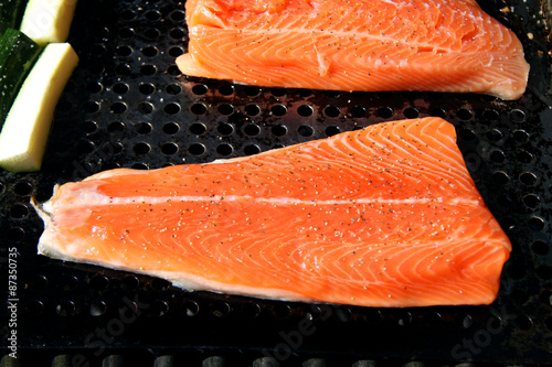 salmon steelhead fillet on the grill raw with zucchini