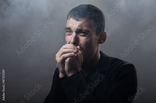 фотографія young man suffocating in the poisonous smoke
