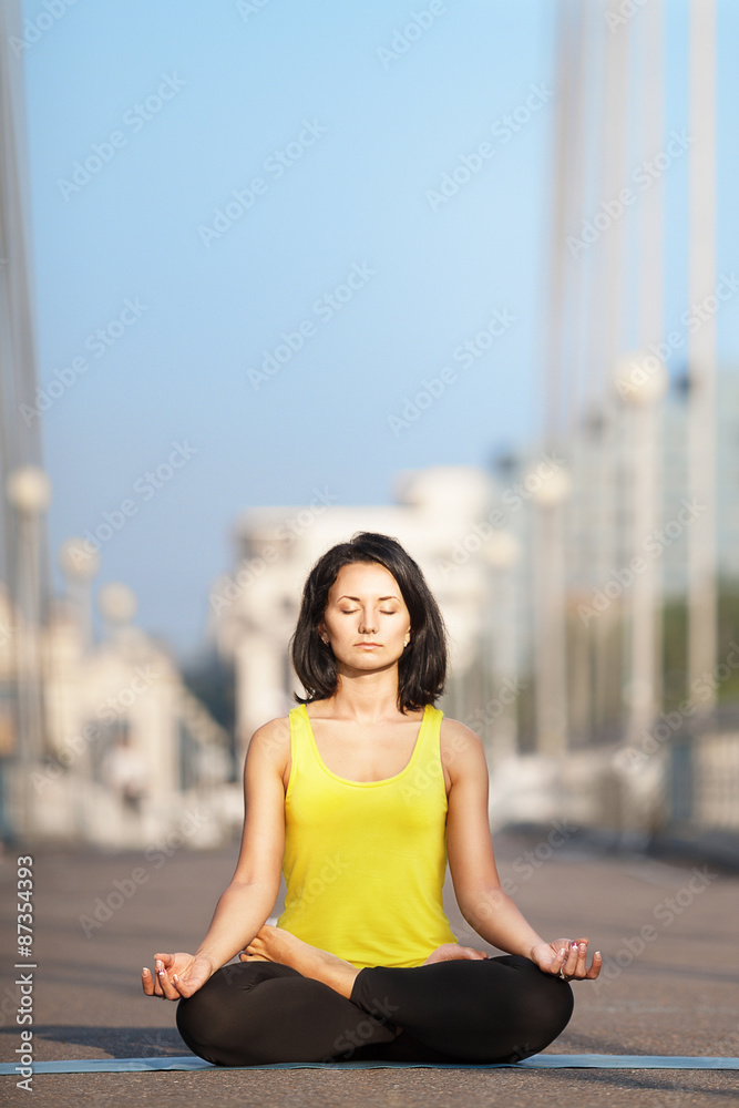 beautiful woman doing yoga on the background of the urban landsc beautiful woman doing yoga on the background of the urban landsc