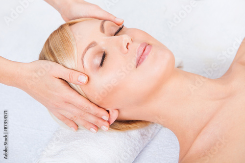 Young attractive beautiful woman getting spa treatment over