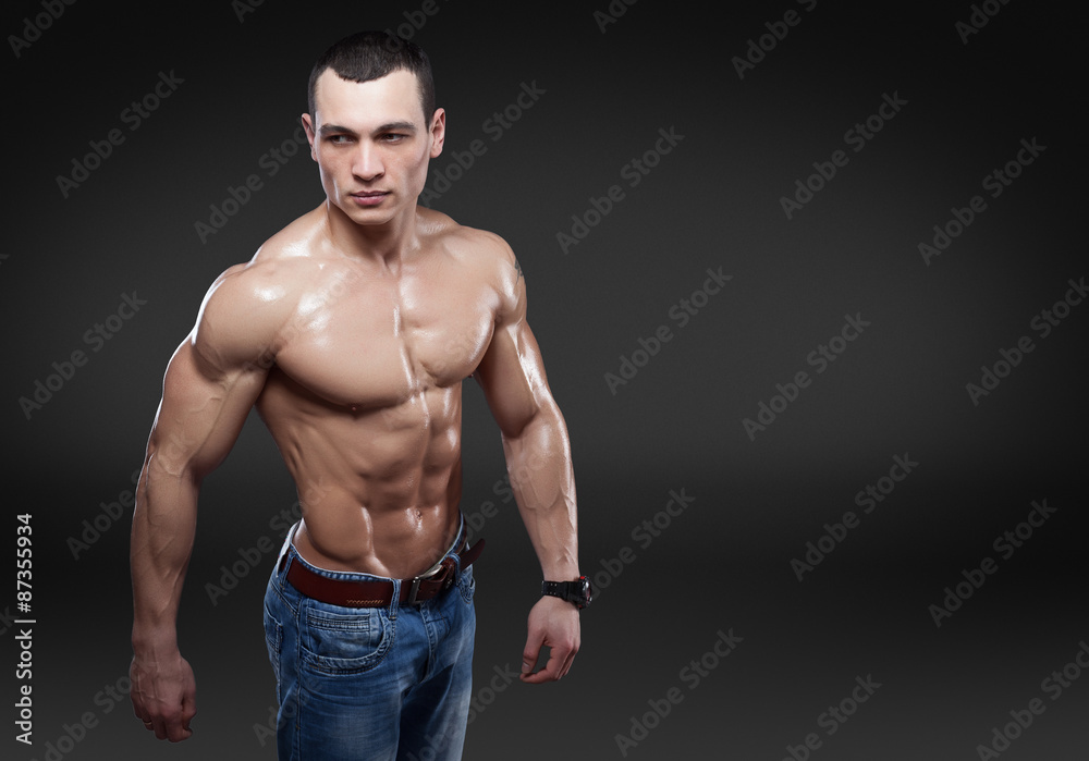 Beautiful muscular male model in jeans