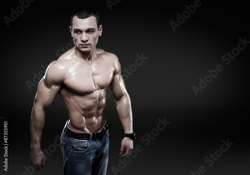 Beautiful muscular male model in jeans