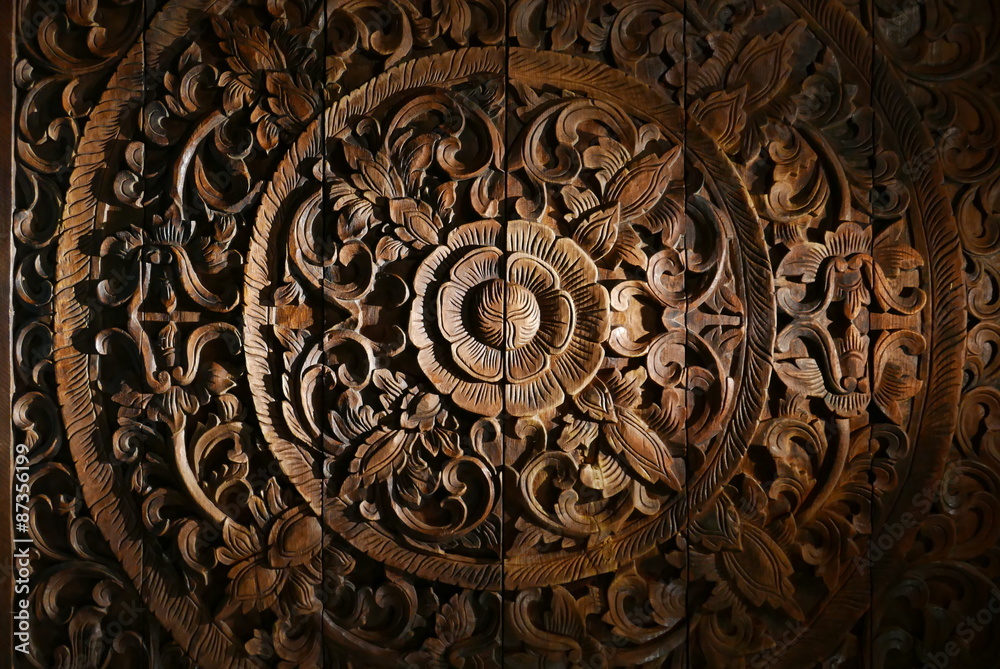 Fototapeta premium Pattern of flower carved on wood background.