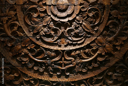 Pattern of flower carved on wood background.