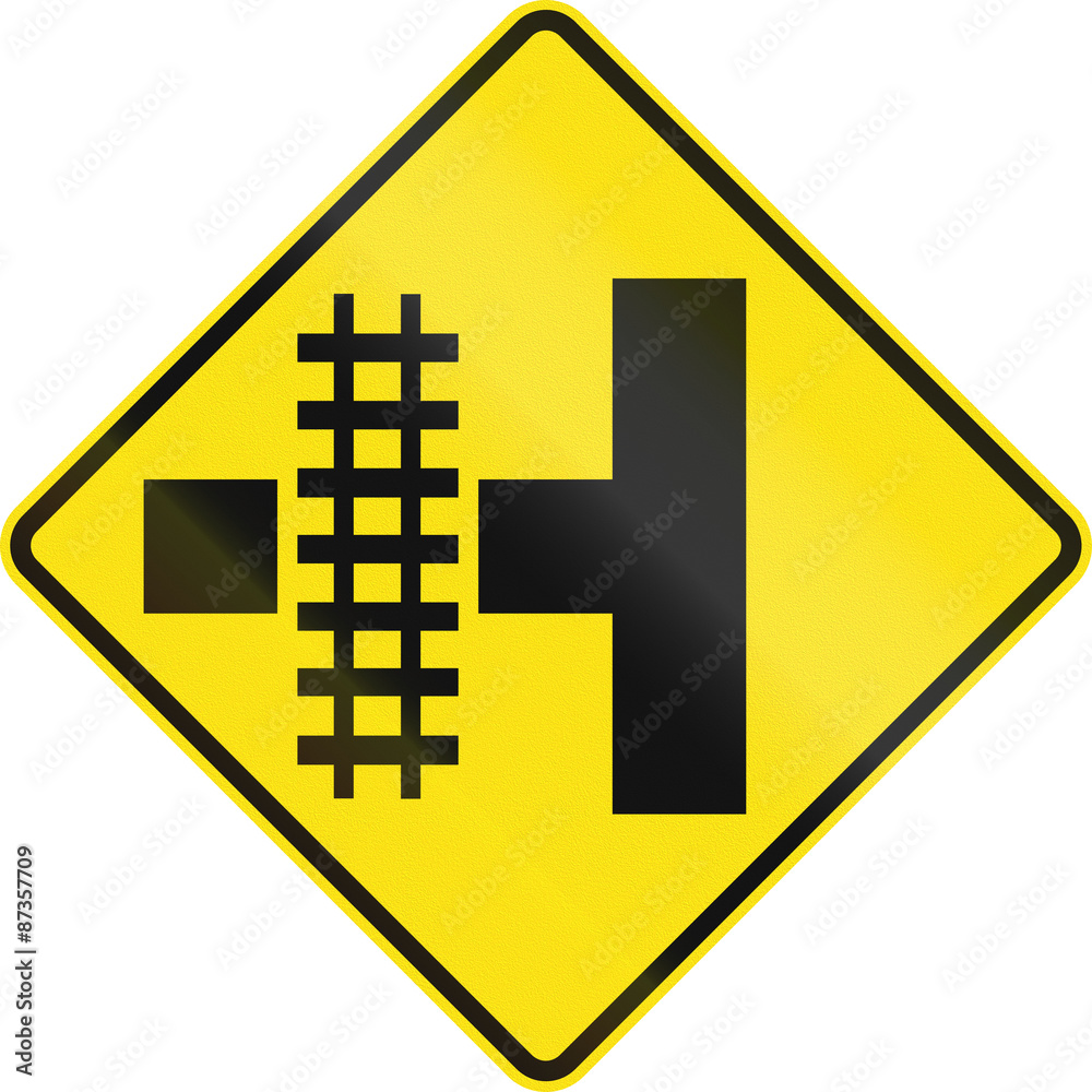 Warning road sign in Australia - Railroad crossing on the left Warning road sign in Australia - Railroad crossing on the left