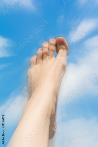 Female foot close up against the sky.