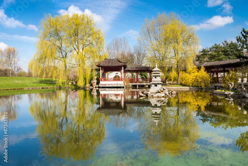 Photography Stone pagoda in the pond of a formal Chinese garden