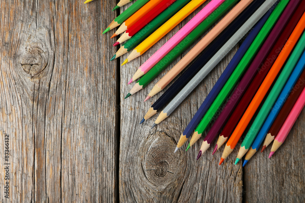 Colour pencils on grey wooden background Colour pencils on grey wooden background