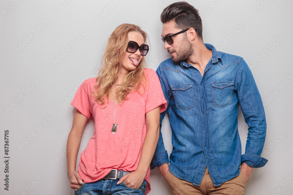 Funny young woman showing her boyfriend her tongue Funny young woman showing her boyfriend her tongue