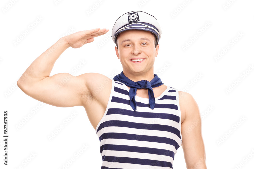 Young male sailor standing straight and saluting towards the cam Young male sailor standing straight and saluting towards the cam