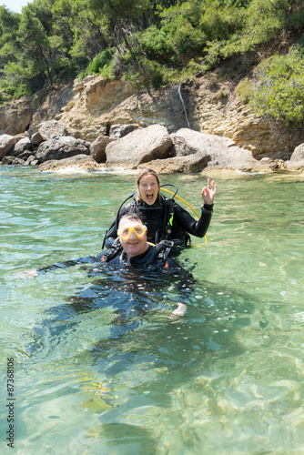 Male and female scuba divers have fun during a rescue diver course