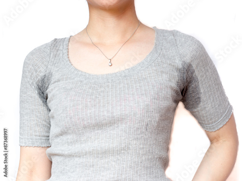 Sweat under arms, young woman with gray shirt