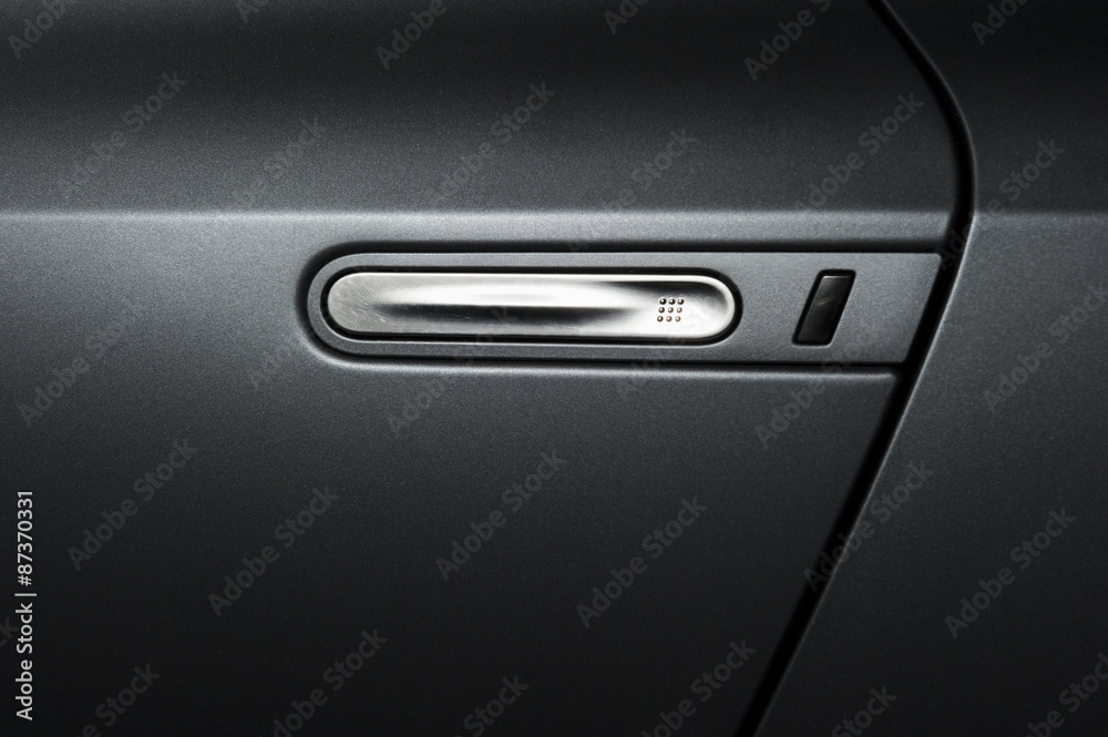 Car handle of vehicle door, modern design, concept, detail of dark grey metallic bodywork, sport powerful sedan Car handle of vehicle door, modern design, concept, detail of dark grey metallic bodywork, sport powerful sedan