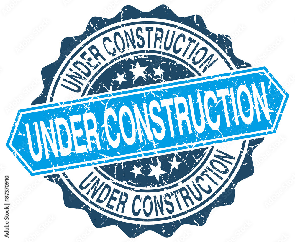 under construction blue round grunge stamp on white under construction blue round grunge stamp on white