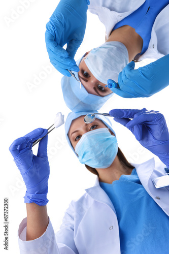 Surgeons team, man and woman wearing protective uniforms,caps