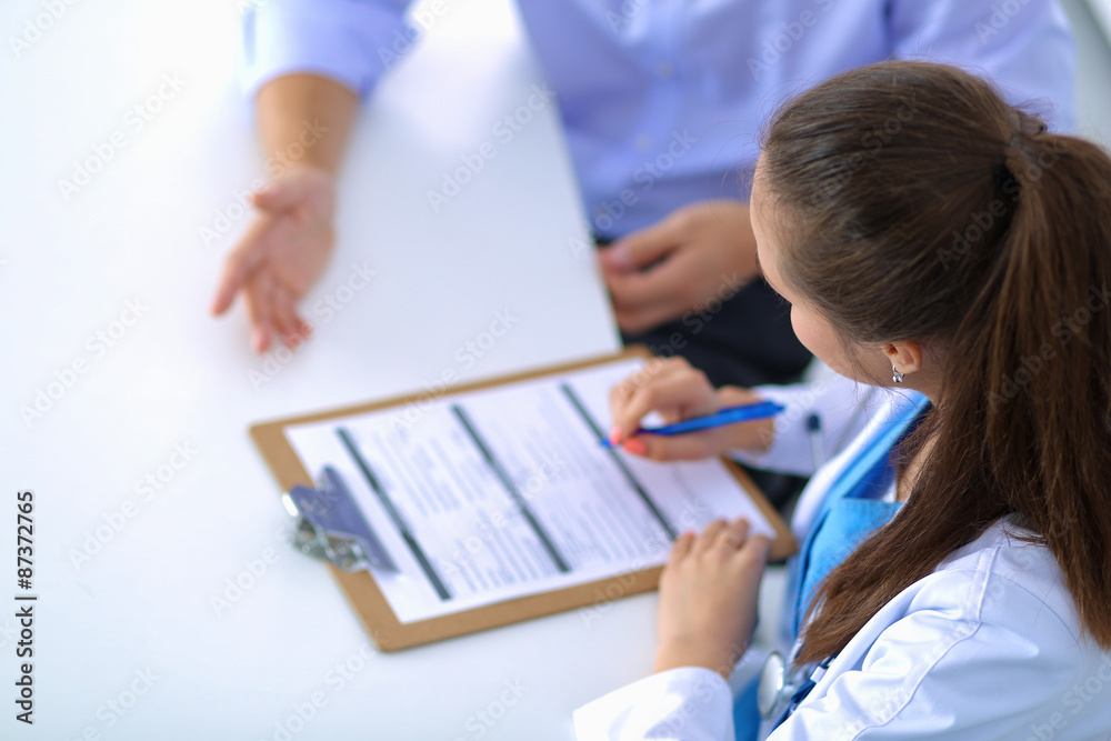Doctor woman sitting with male patient at the desk Doctor woman sitting with male patient at the desk
