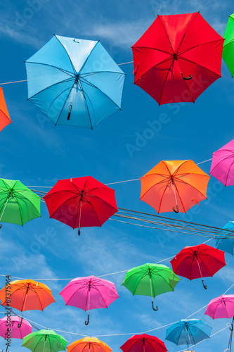Streets are decorated with colorful umbrellas.  