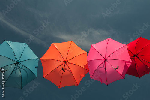 Streets are decorated with colorful umbrellas.  