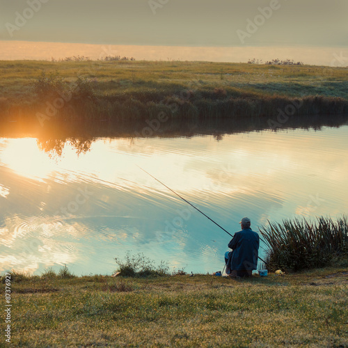 Fisherman fishing. A fisherman catches a fish in the morning