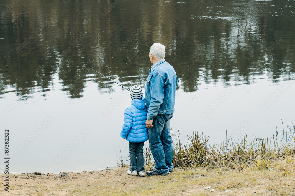 Grandfather and grandson are fishing Grandfather and grandson are fishing