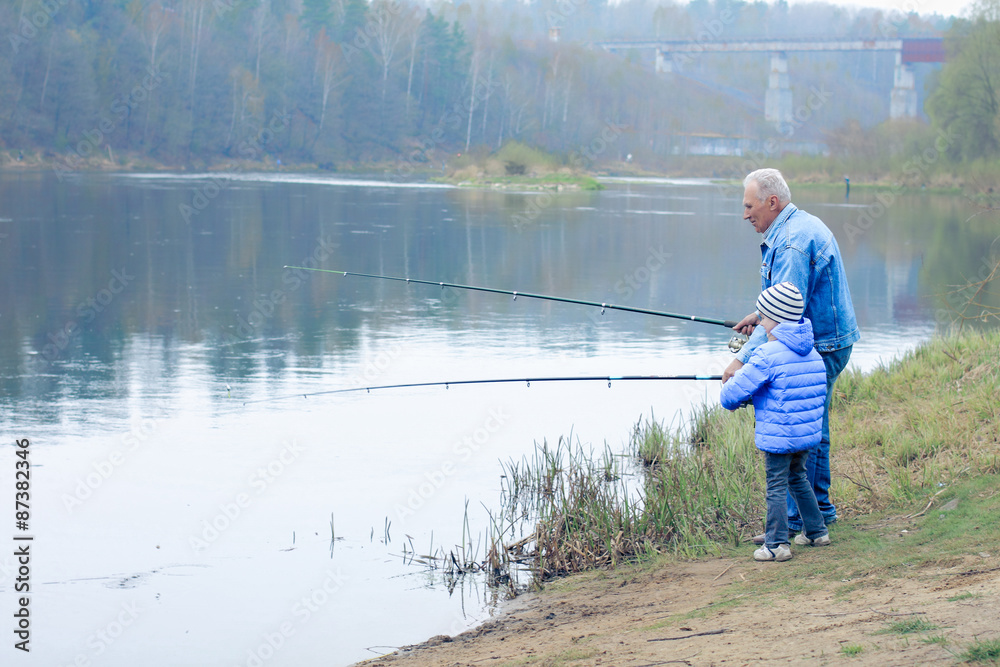Grandfather and grandson are fishing Grandfather and grandson are fishing