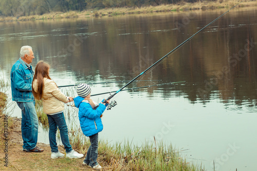 Grandfather and grandchildren are fishing