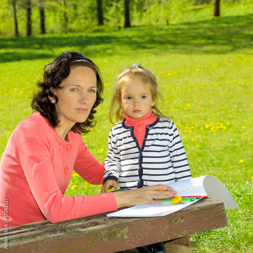 Mother & little daughter paint outdoors