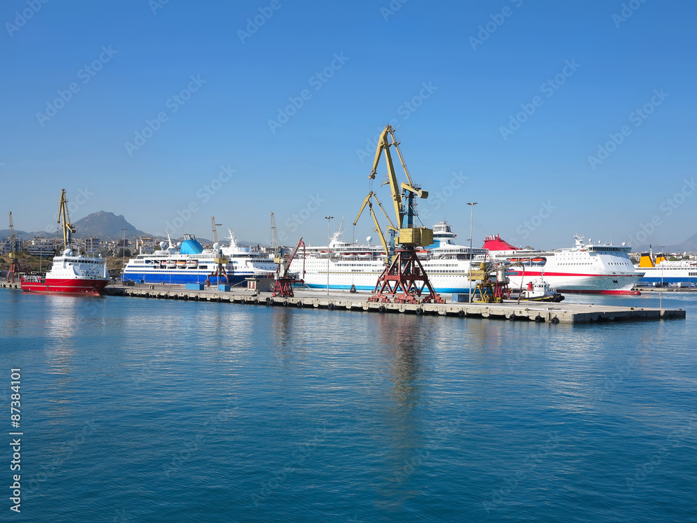 Crane and big ships in a sea port blue sea