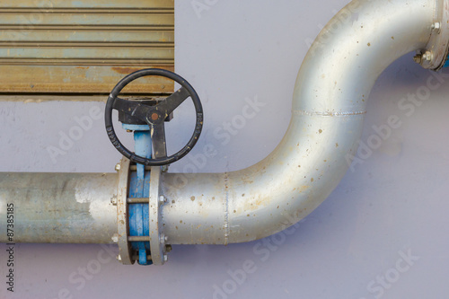 pipe and water valve outdoor building photo