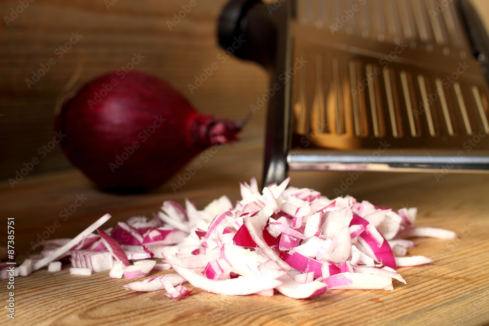 Chopped onions mandolin. Chopped red onion with mandolin on wooden  background. Stock Photo | Adobe Stock