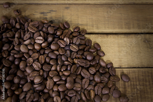Coffee beans on grunge wooden background, Fresh coffee beans on © orijinal_x