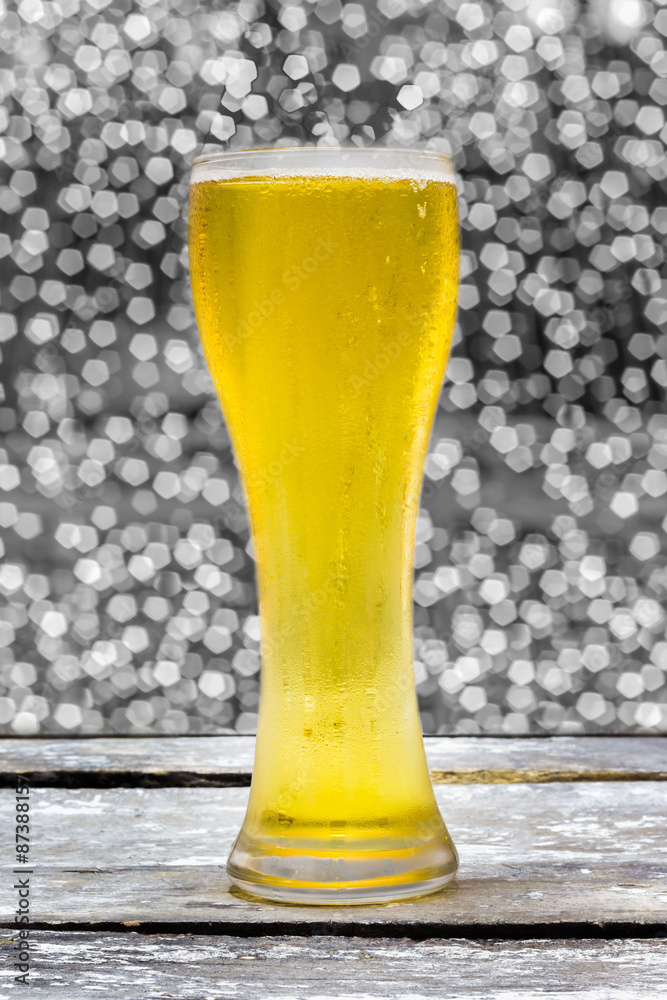 Beer in glass on a wooden table background blur.