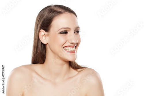 young smiling woman looking aside on a white background