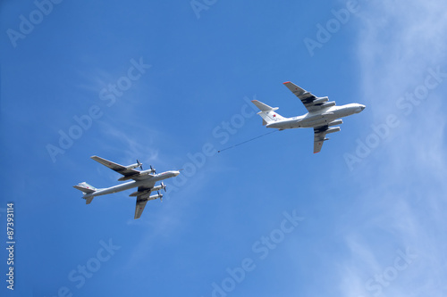 Military transport plane Il-78 refueling tankers and Tu-95 turboprop strategic bomber in flight