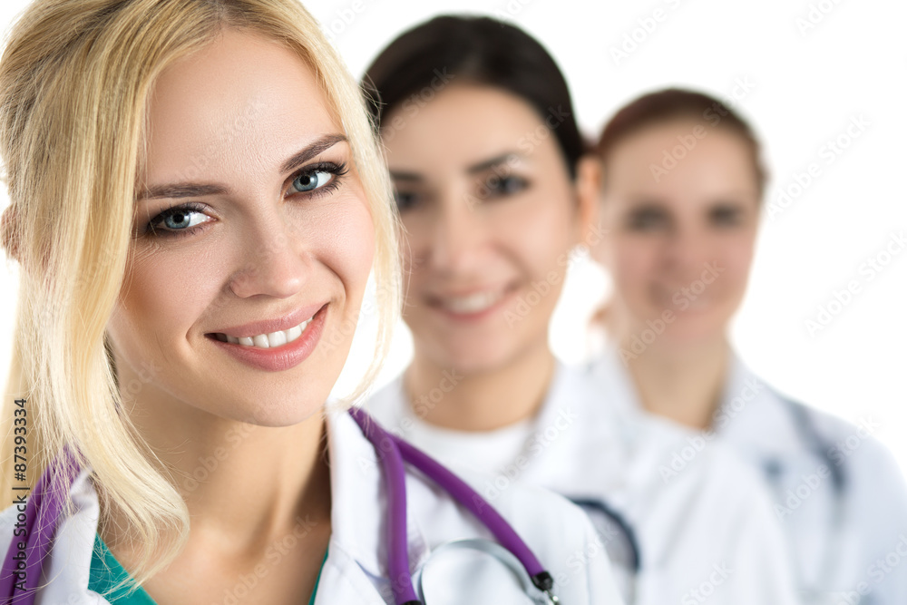 Portrait of young blonde female doctor surrounded by medical tea