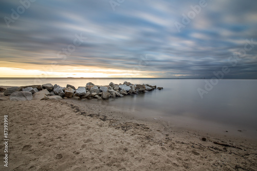  Sunrise over the sea. Beautiful long exposure landscape of rocky shore