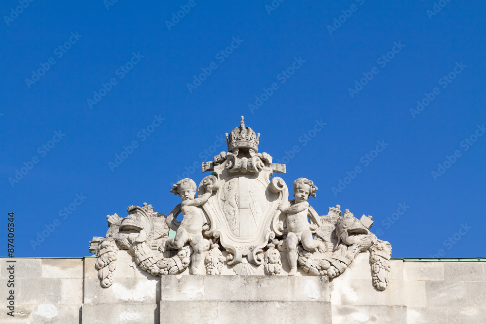 Ornamental baby angels holding a royal shield