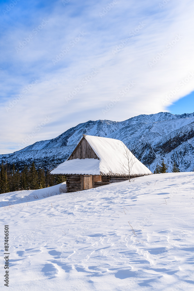 Wooden mountain hut in winter landscape of Gasienicowa valley, Tatra Mountains, Poland Wooden mountain hut in winter landscape of Gasienicowa valley, Tatra Mountains, Poland